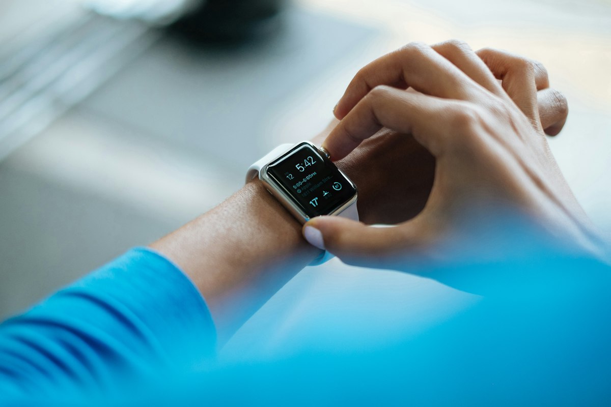 A person checking health data on a smartwatch